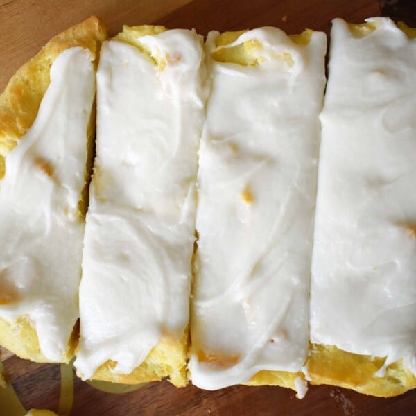 Swedish Pastry by Modern Honey. Buttery flaky layers with almond filling and topped with sweet cream frosting. A popular homemade European pastry. This can also be called a Danish Kringle or Danish pastry.