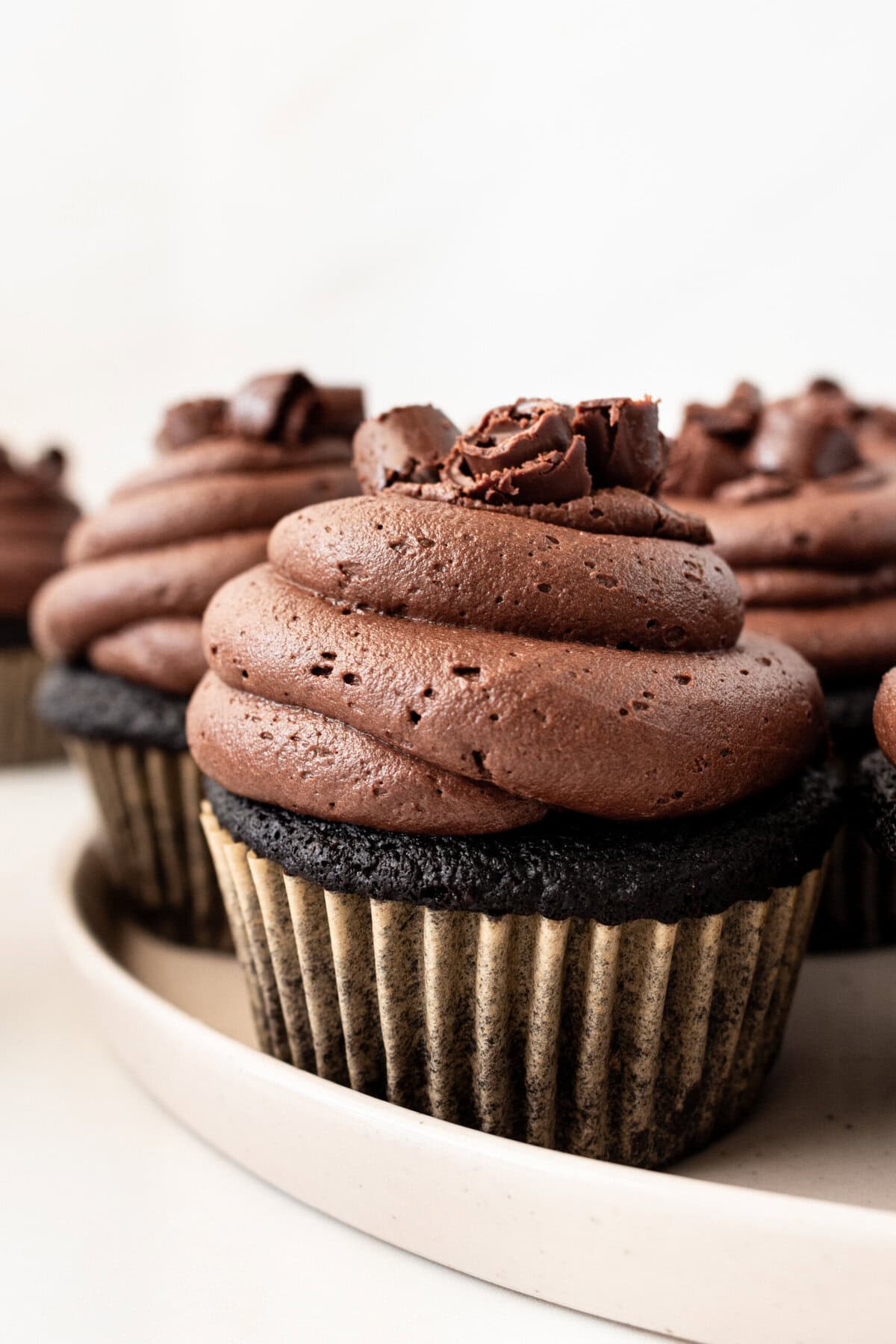 This is the Ultimate Chocolate Cupcake Recipe, with a rich, moist chocolate cake with a tender crumb and a velvet chocolate frosting. These are the best chocolate cupcakes you'll ever taste, with a deep cocoa flavor that melts in your mouth. Not only are they delicious, but this easy chocolate cupcake recipe takes just minutes to prepare. If you are looking for moist chocolate cupcakes that are 5-star rated, this is the recipe for you!