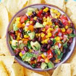 Cowboy Caviar. A popular, crowd-pleasing appetizer made with black beans, corn, tomatoes, cilantro, avocado, peppers, all tossed in a zesty dressing. www.modernhoney.com #cowboycaviar #appetizer #salsa #cornsalsa #blackbeansalsa #appetizers