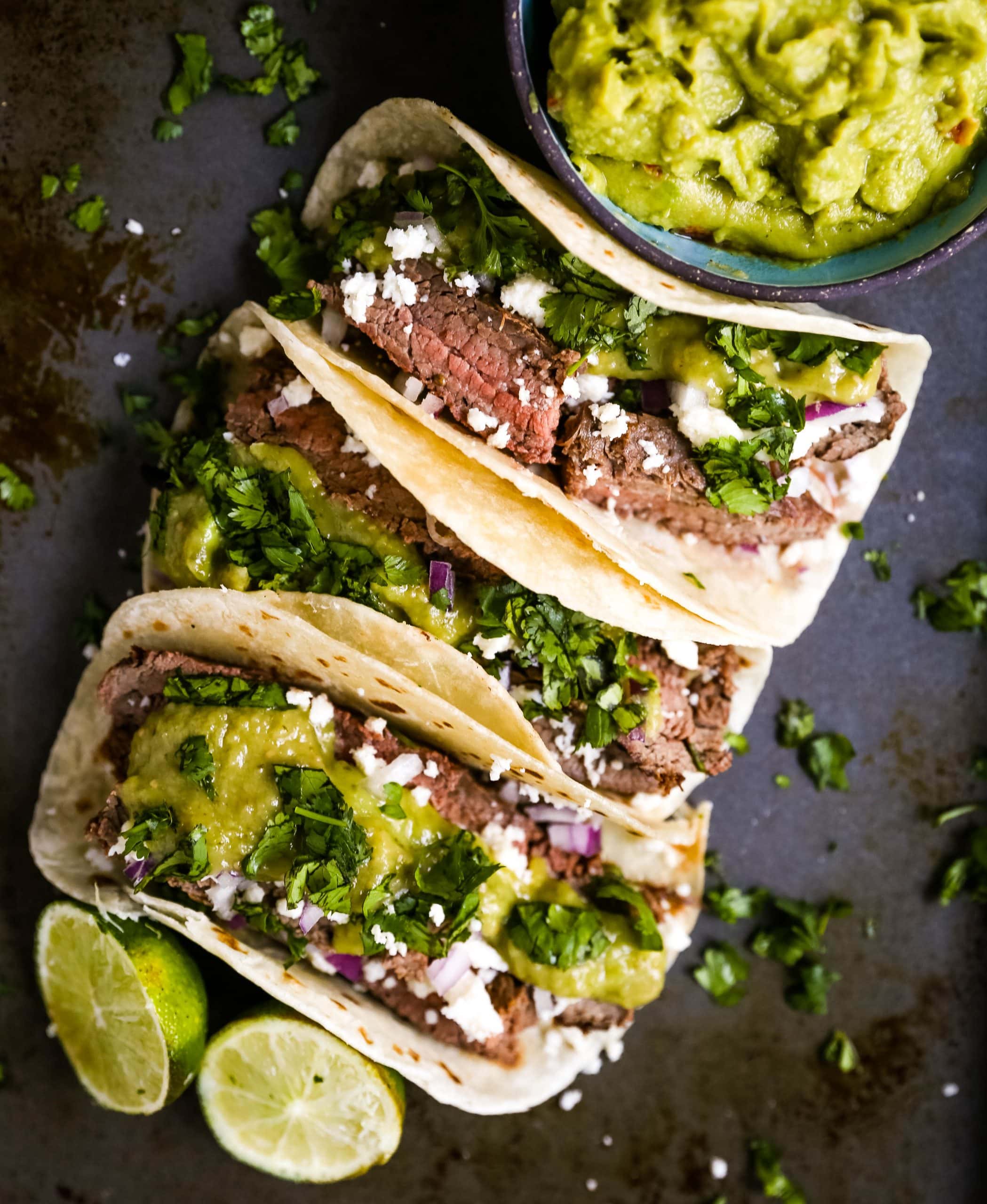 Grilled Steak Tacos. Juicy marinated grilled steak tacos with fresh cilantro, avocado, and salsa. The most flavorful and tender steak tacos recipe! www.modernhoney.com #tacos #steaktacos #steak #beeftacos