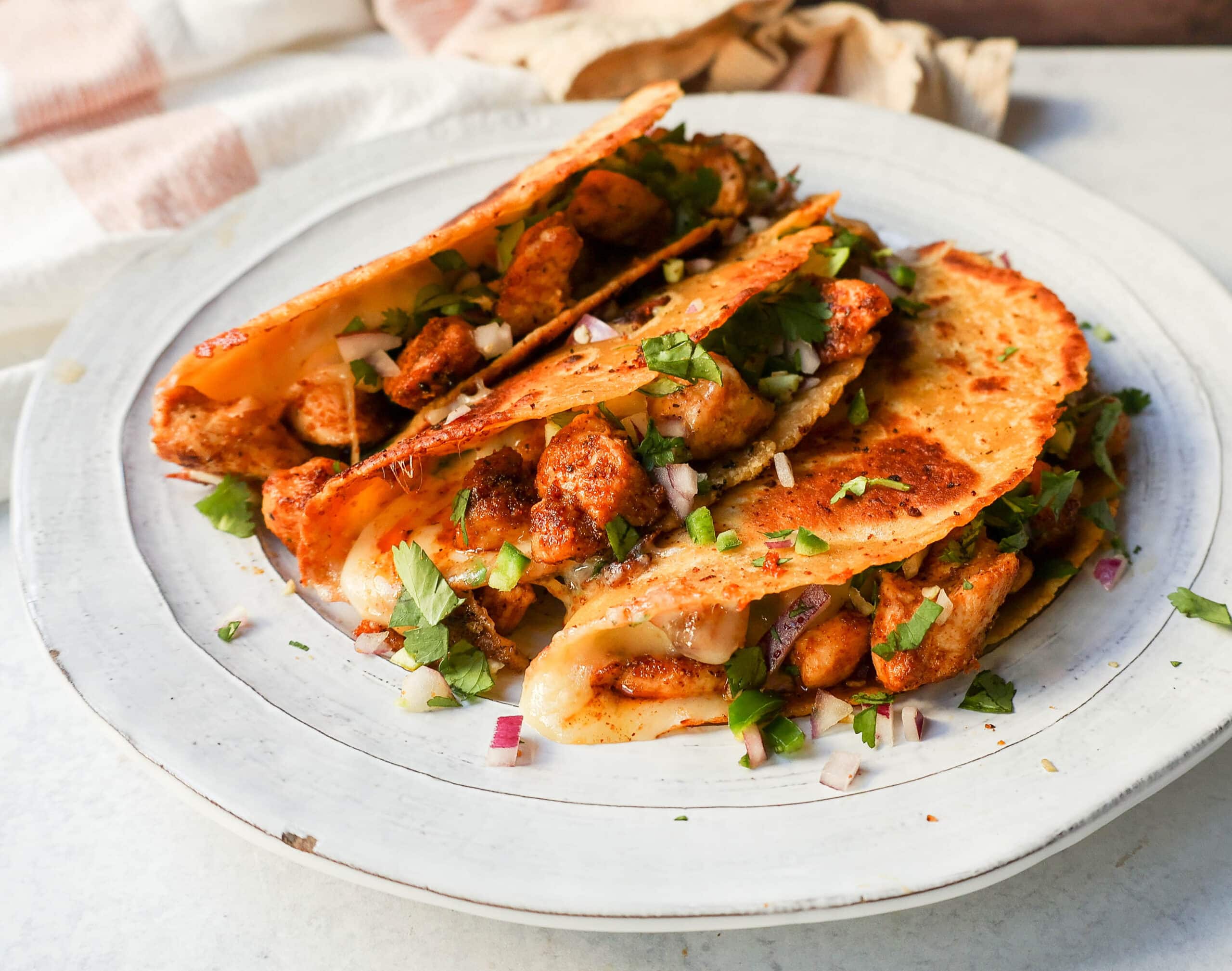 Chipotle Spiced Chicken Tacos with a cheese-filled tortilla and topped with fresh salsa. These easy chicken tacos are made in less than 20 minutes and are so popular!