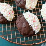 White Chocolate Dipped Peppermint Chocolate Cookies. The Double Chocolate Peppermint Cookies are soft baked, rich double chocolate brownie cookies dipped in white chocolate and covered with peppermint candy canes. The perfect Christmas holiday cookie recipe.