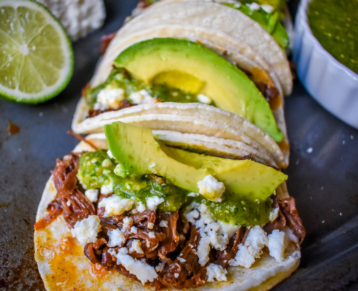 Slow Cooker Beef Barbacoa Tacos with Salsa Verde. These Barbacoa Beef Tacos with Tomatillo Salsa are made with slow cooked, Mexican spiced beef inside fresh corn tortillas and topped with homemade salsa verde, Mexican cheese, and fresh avocado. An easy and flavorful beef tacos recipe!