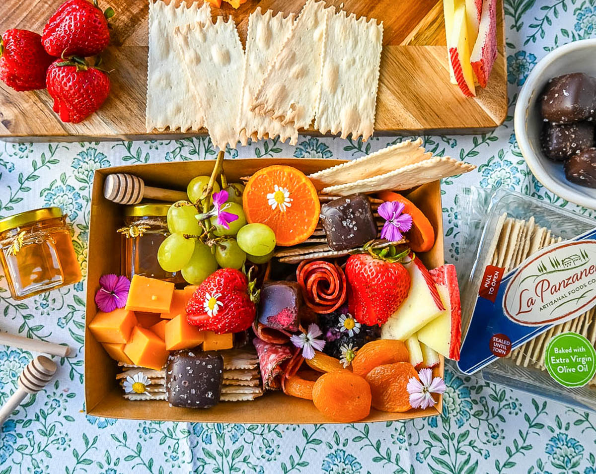 Charcuterie boards have become the epitome of gourmet snacking. But what if you are craving a charcuterie board but you want it on a smaller scale? Enter the mini charcuterie box – a perfect personal-sized grazing box that packs all the flavor in a small package. 