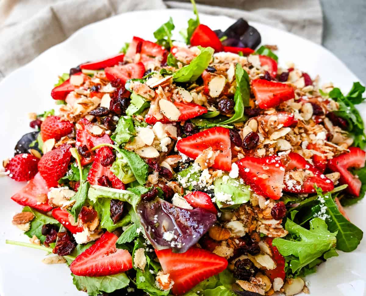 Strawberry Spring Mix Salad. This Strawberry Poppyseed Salad is made with spring mix, fresh strawberries, creamy and tangy feta cheese, sugared almonds, and tossed with a sweet homemade poppyseed dressing. 