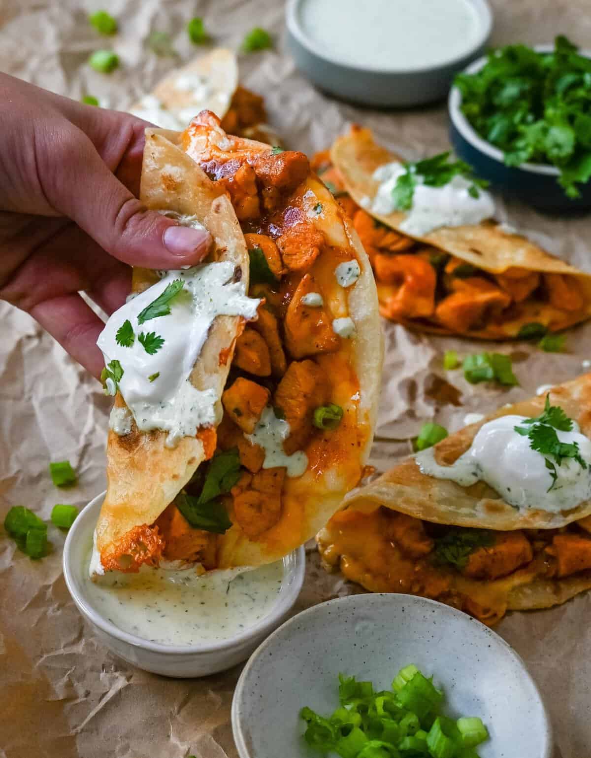 These Crispy Buffalo Chicken Tacos with Jalapeno Ranch Dressing are made with spicy buffalo chicken, melted cheese, drizzled with a homemade cilantro jalapeno ranch. Whether you’re hosting a game day party, preparing a family dinner, or looking for a fun and flavorful meal, these buffalo chicken tacos are a hit!