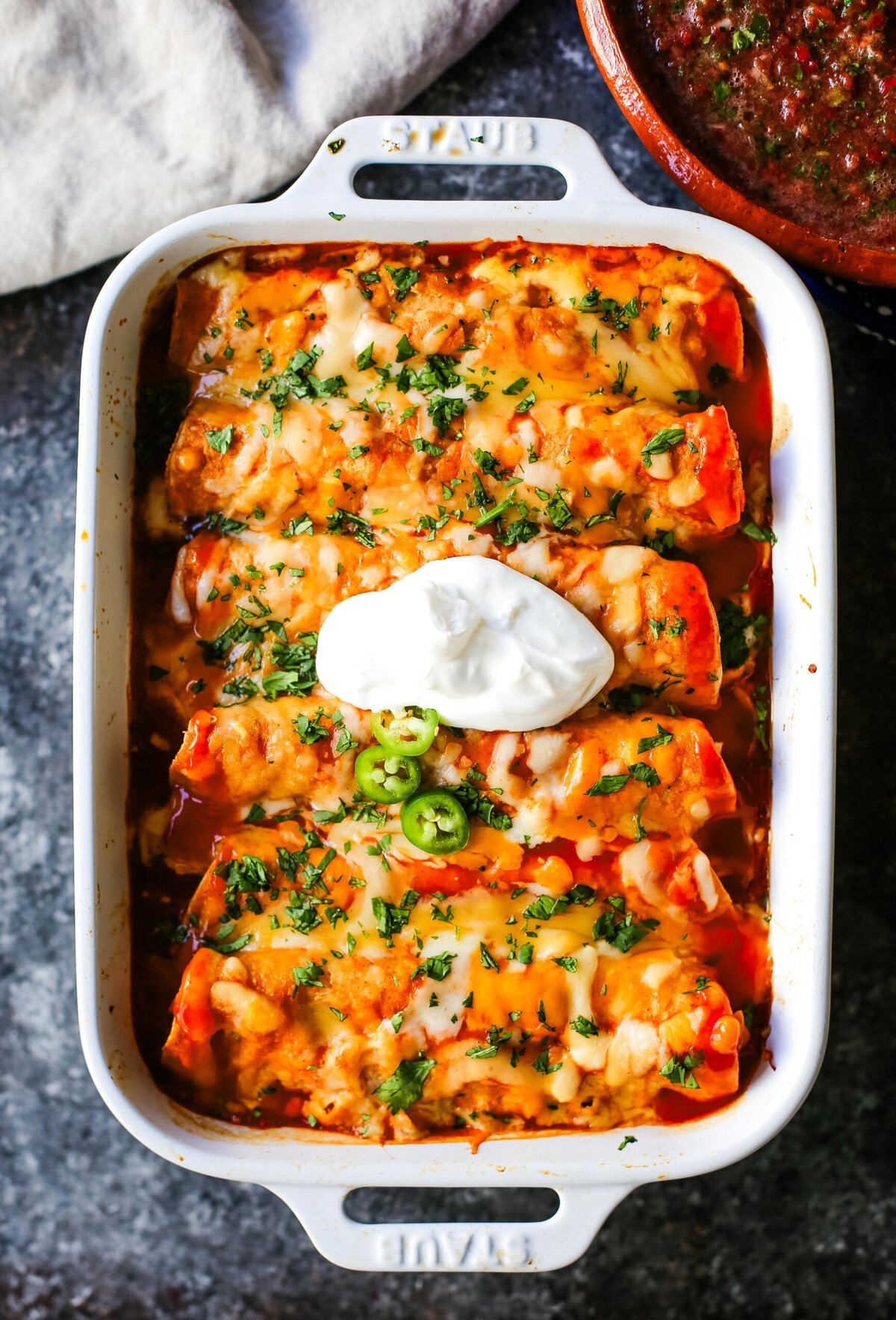 How to make Quick and Easy Chicken Enchiladas with only a few ingredients. This delicious chicken enchiladas recipe is super simple and a crowd pleaser.