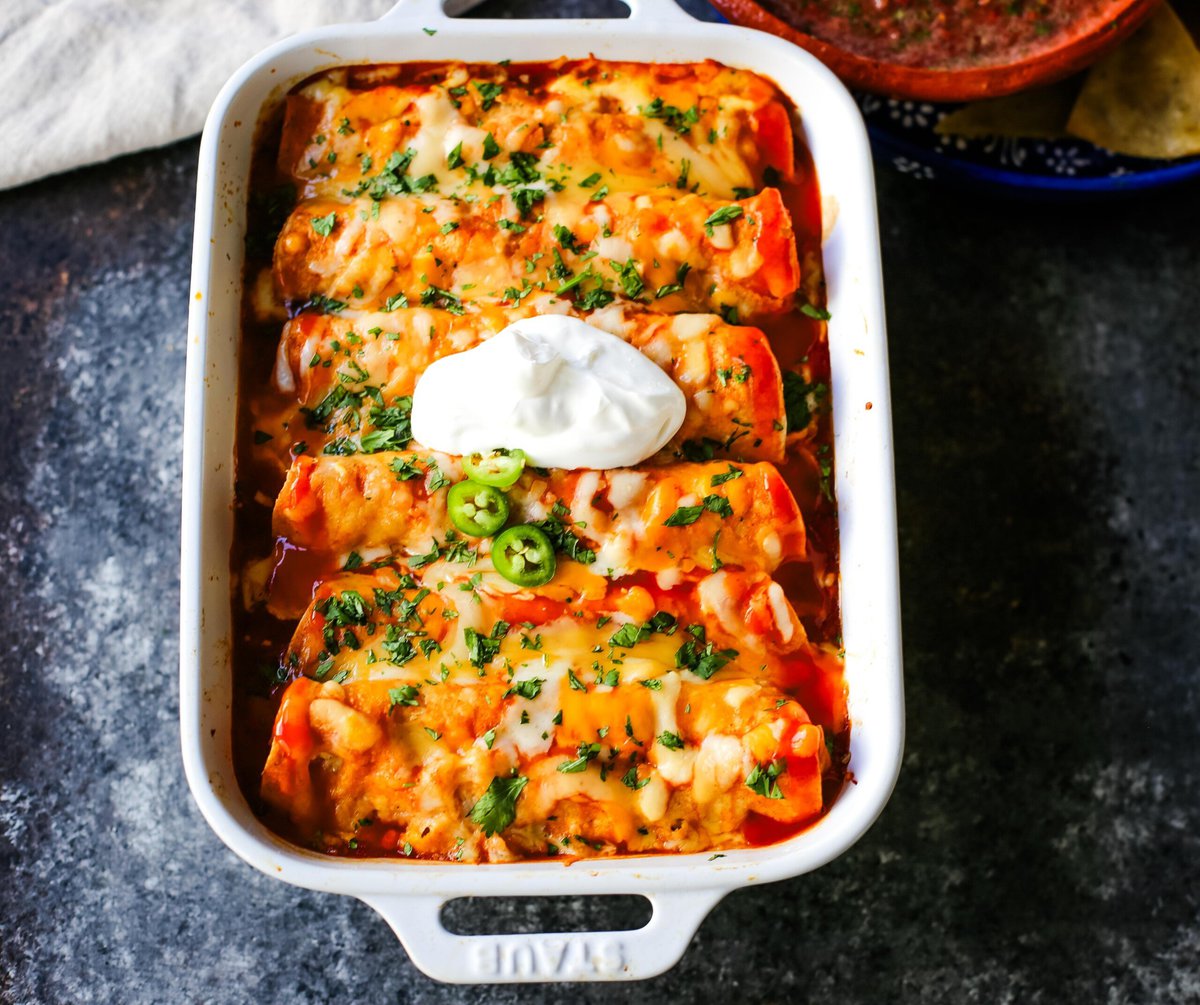 How to make Quick and Easy Chicken Enchiladas with only a few ingredients. This delicious chicken enchiladas recipe is super simple and a crowd pleaser.