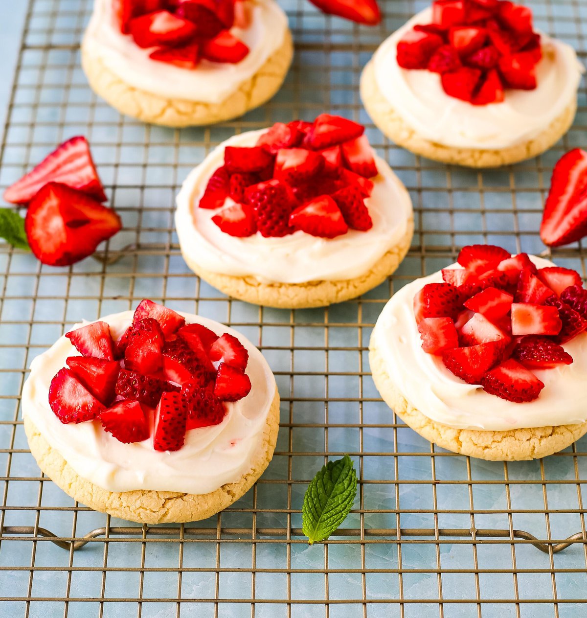 These Frosted Strawberries and Cream Cookies are soft, buttery sugar cookies topped with velvety smooth, sweet cream cheese frosting and topped with fresh strawberries. The perfect frosted strawberry cookie recipe!