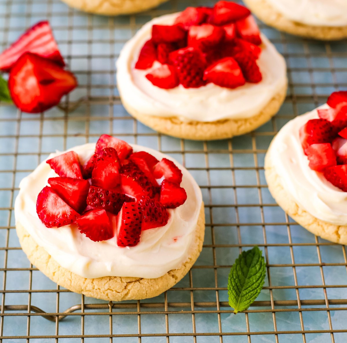 These Frosted Strawberries and Cream Cookies are soft, buttery sugar cookies topped with velvety smooth, sweet cream cheese frosting and topped with fresh strawberries. The perfect frosted strawberry cookie recipe!