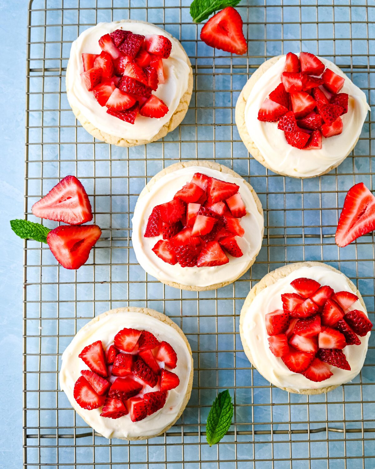 These Frosted Strawberries and Cream Cookies are soft, buttery sugar cookies topped with velvety smooth, sweet cream cheese frosting and topped with fresh strawberries. The perfect frosted strawberry cookie recipe!