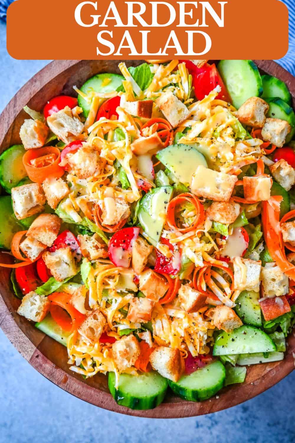 This fresh garden salad recipe is made with crisp lettuce, tomatoes, carrot ribbons, cucumbers, cheddar and mozzarella cheeses, homemade croutons, all tossed with a honey mustard or ranch dressing.