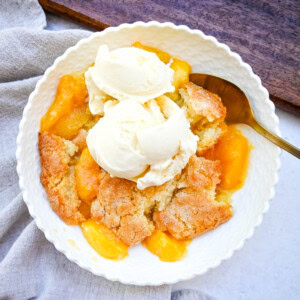 This Homemade Nectarine Cobbler is made with fresh nectarines tossed in sugar and topped with a golden, buttery crust and served warm with vanilla bean ice cream. This is the best nectarine cobbler recipe!