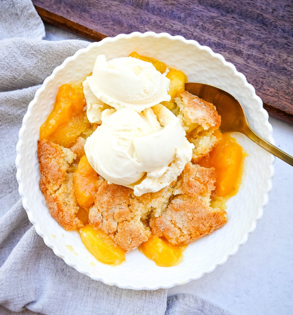 This Homemade Nectarine Cobbler is made with fresh nectarines tossed in sugar and topped with a golden, buttery crust and served warm with vanilla bean ice cream. This is the best nectarine cobbler recipe!