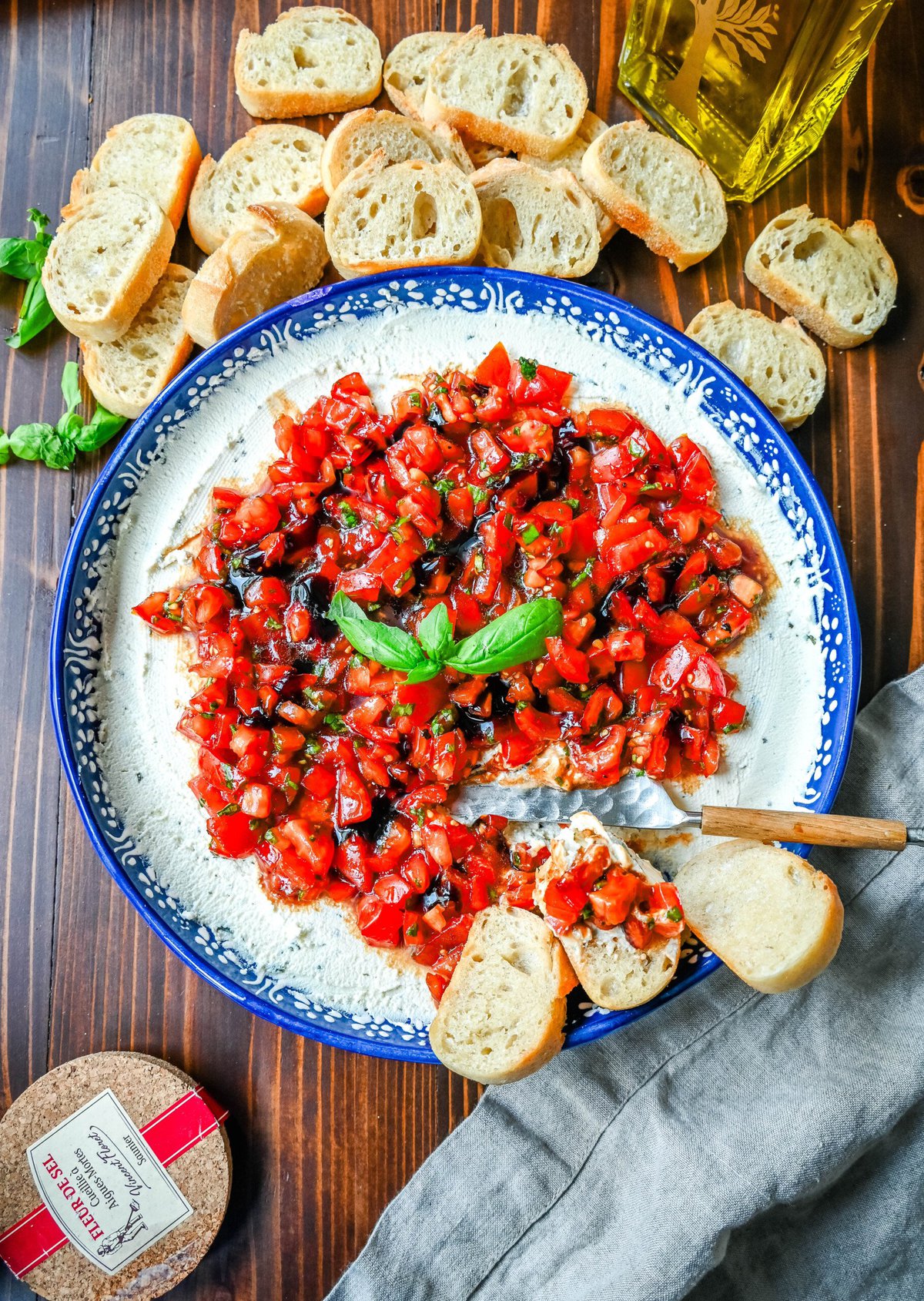 This quick and easy appetizer is made with garlic and herb Boursin cheese and topped with a fresh caprese salad made with tomatoes, olive oil, balsamic glaze, basil, and garlic. This Caprese Dip with boursin cheese pairs perfectly with crostinis or crackers.