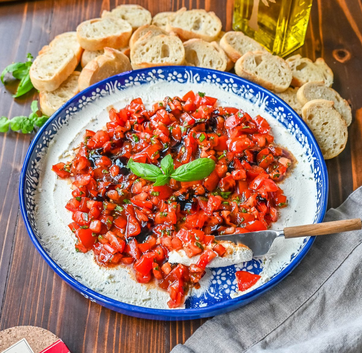 This quick and easy appetizer is made with garlic and herb Boursin cheese and topped with a fresh caprese salad made with tomatoes, olive oil, balsamic glaze, basil, and garlic. This Caprese Dip with boursin cheese pairs perfectly with crostinis or crackers.