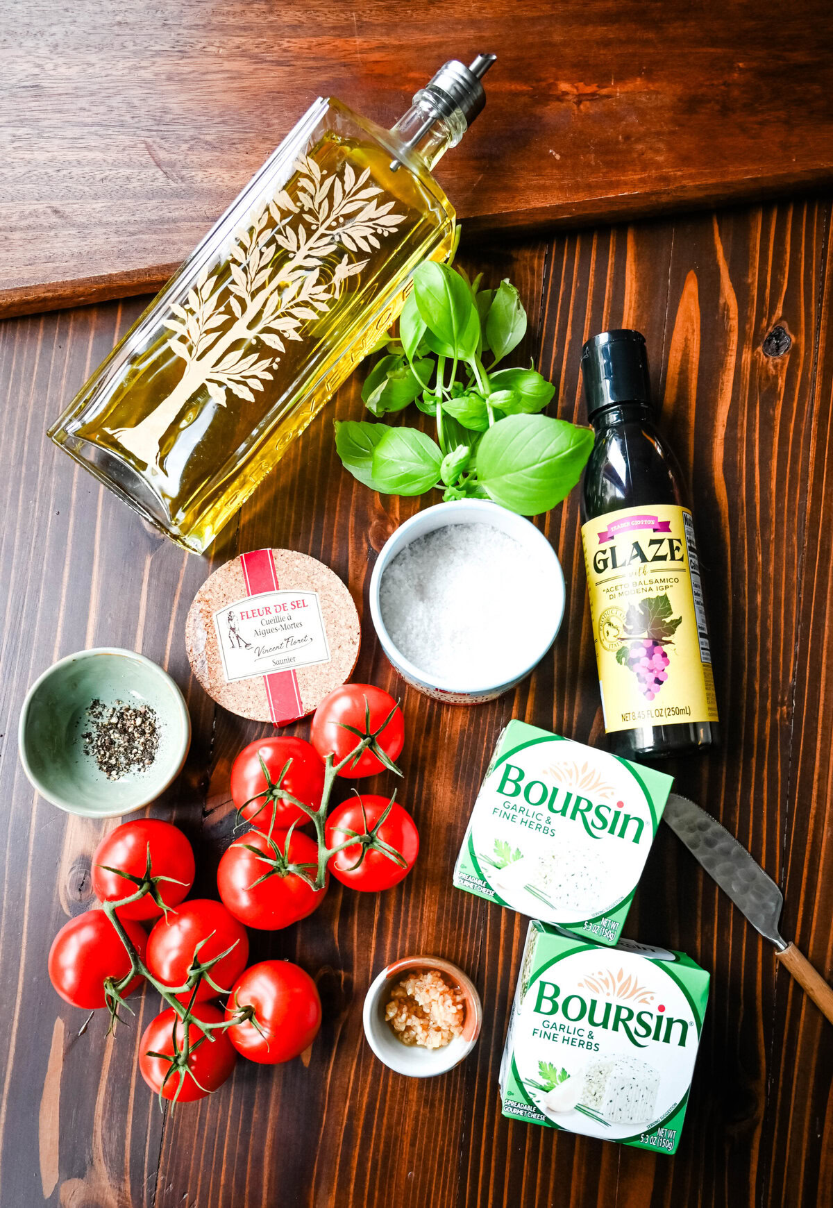 Caprese Dip Ingredients. This quick and easy appetizer is made with garlic and herb Boursin cheese and topped with a fresh caprese salad made with tomatoes, olive oil, balsamic glaze, basil, and garlic. This Caprese Dip with boursin cheese pairs perfectly with crostinis or crackers.