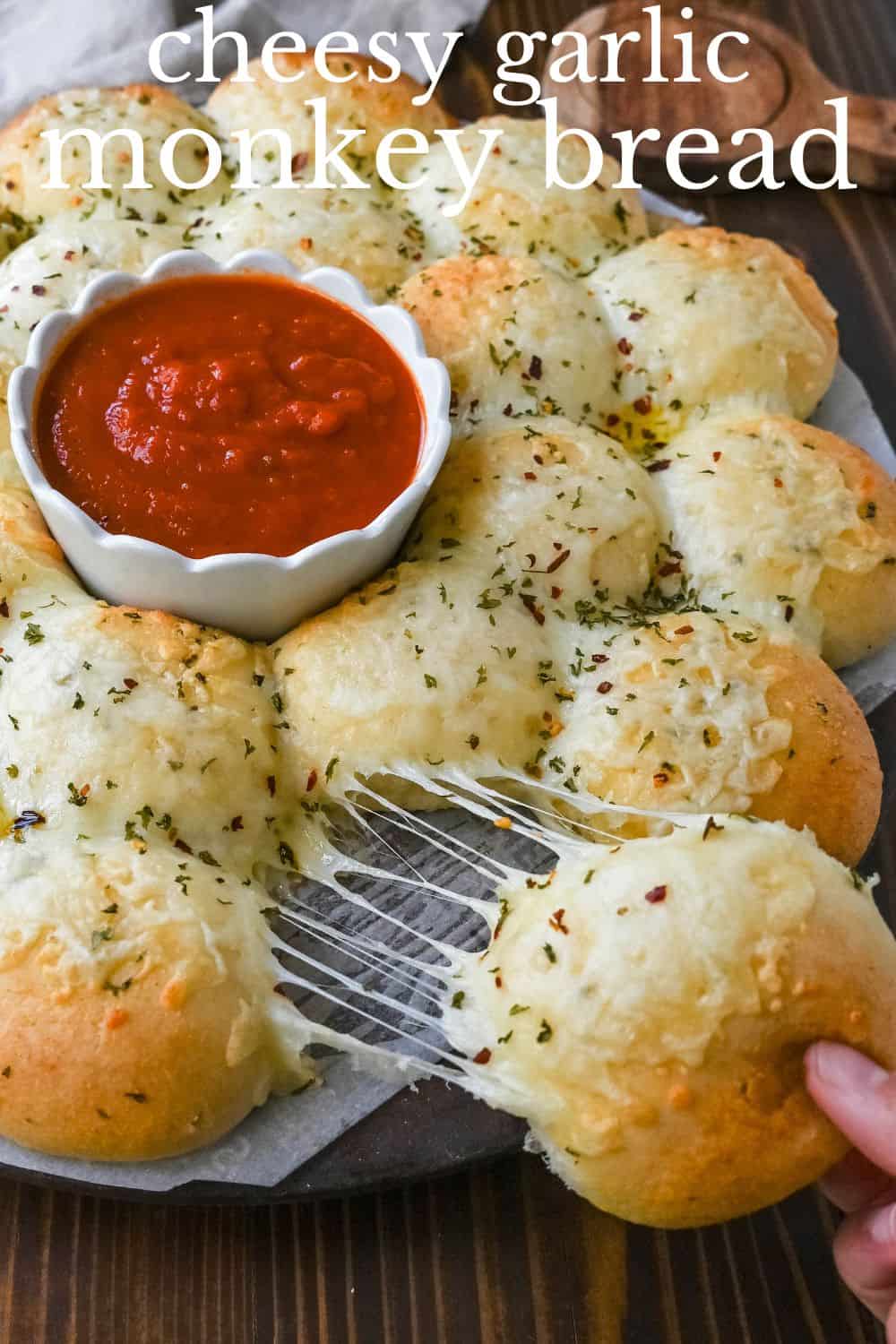 Cheesy garlic monkey bread, or garlic cheese pull-apart bread, made with Rhodes frozen dinner rolls, is soft, buttery, and cheesy. Each roll is dipped in garlic butter and then topped with gooey, melted mozzarella cheese that bubbles as it bakes. The result is a pull-apart bread that's golden on the outside, fluffy on the inside, and has cheesy, garlicky goodness in every bite.