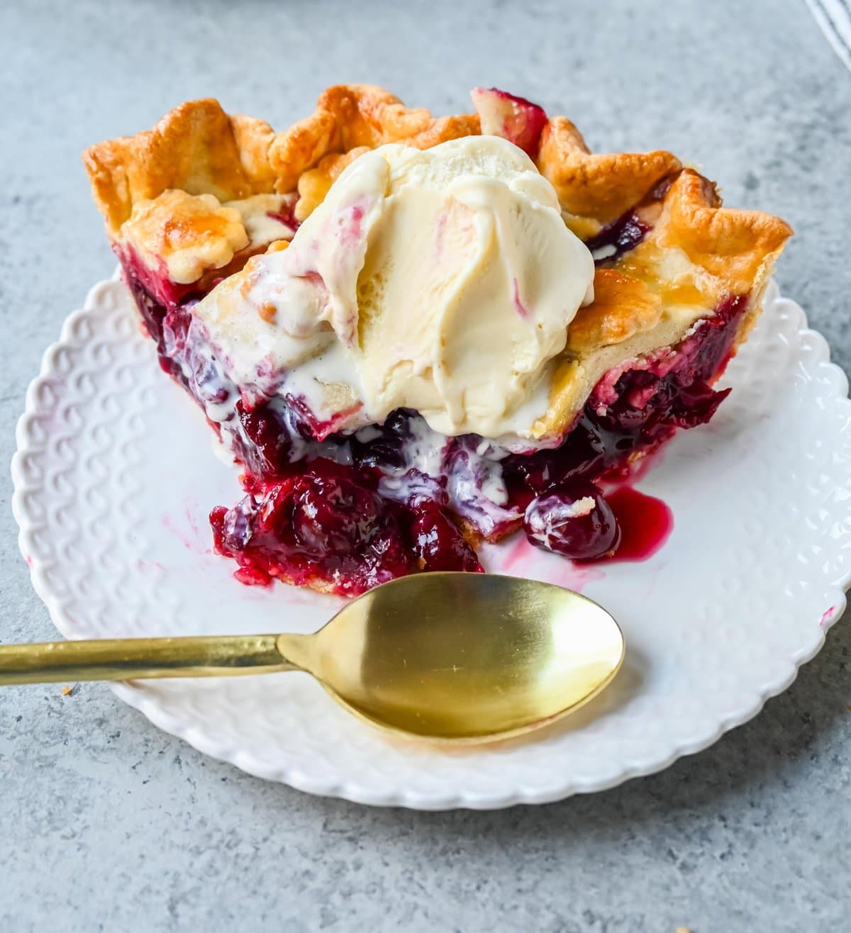 Homemade cherry pie is bursting with sweet-tart cherries nestled in a flaky, golden crust and topped with vanilla bean ice cream. I am sharing tips and tricks for making sweet cherry pie at home.