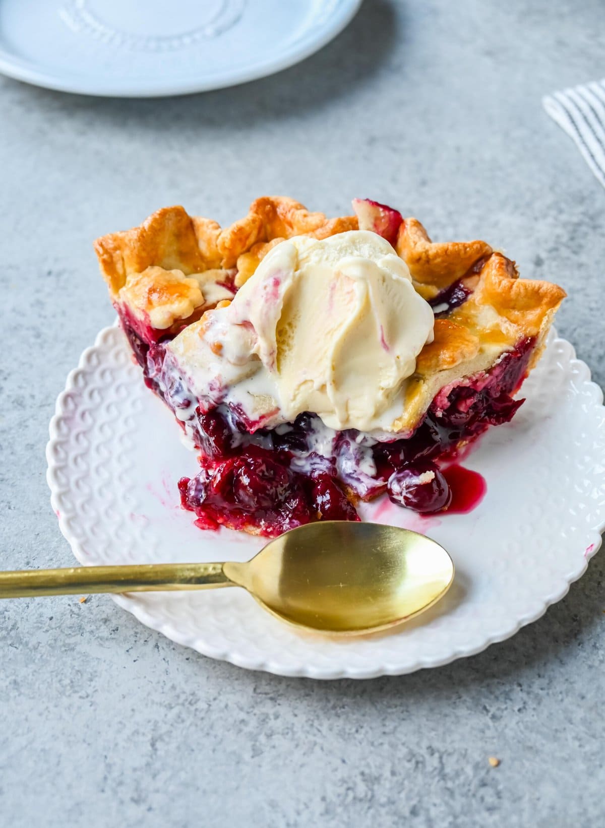 Homemade cherry pie is bursting with sweet-tart cherries nestled in a flaky, golden crust and topped with vanilla bean ice cream. I am sharing tips and tricks for making sweet cherry pie at home.