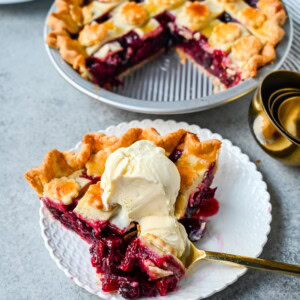 Homemade cherry pie is bursting with sweet-tart cherries nestled in a flaky, golden crust and topped with vanilla bean ice cream. I am sharing tips and tricks for making sweet cherry pie at home.