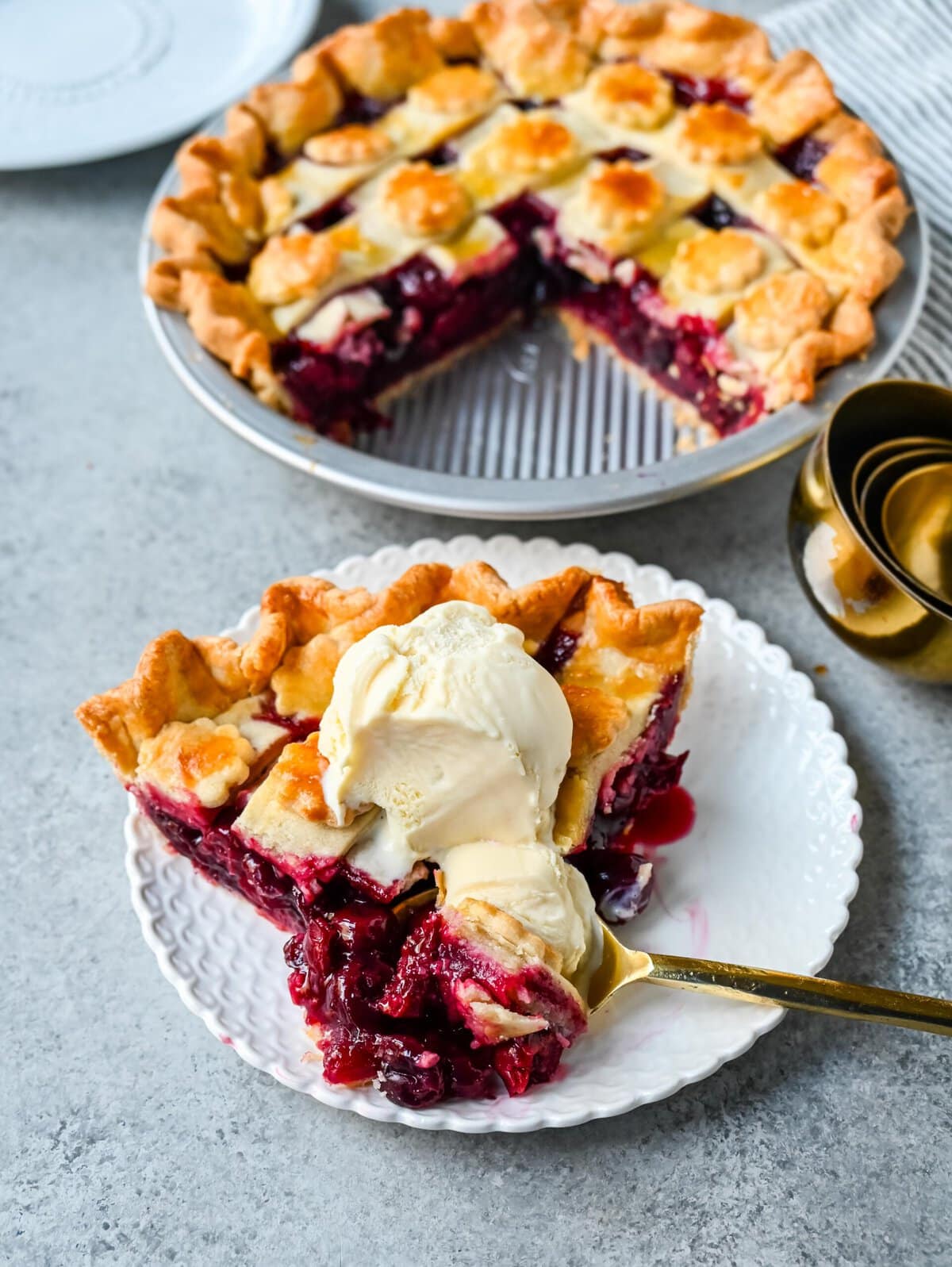 Homemade cherry pie is bursting with sweet-tart cherries nestled in a flaky, golden crust and topped with vanilla bean ice cream. I am sharing tips and tricks for making sweet cherry pie at home.