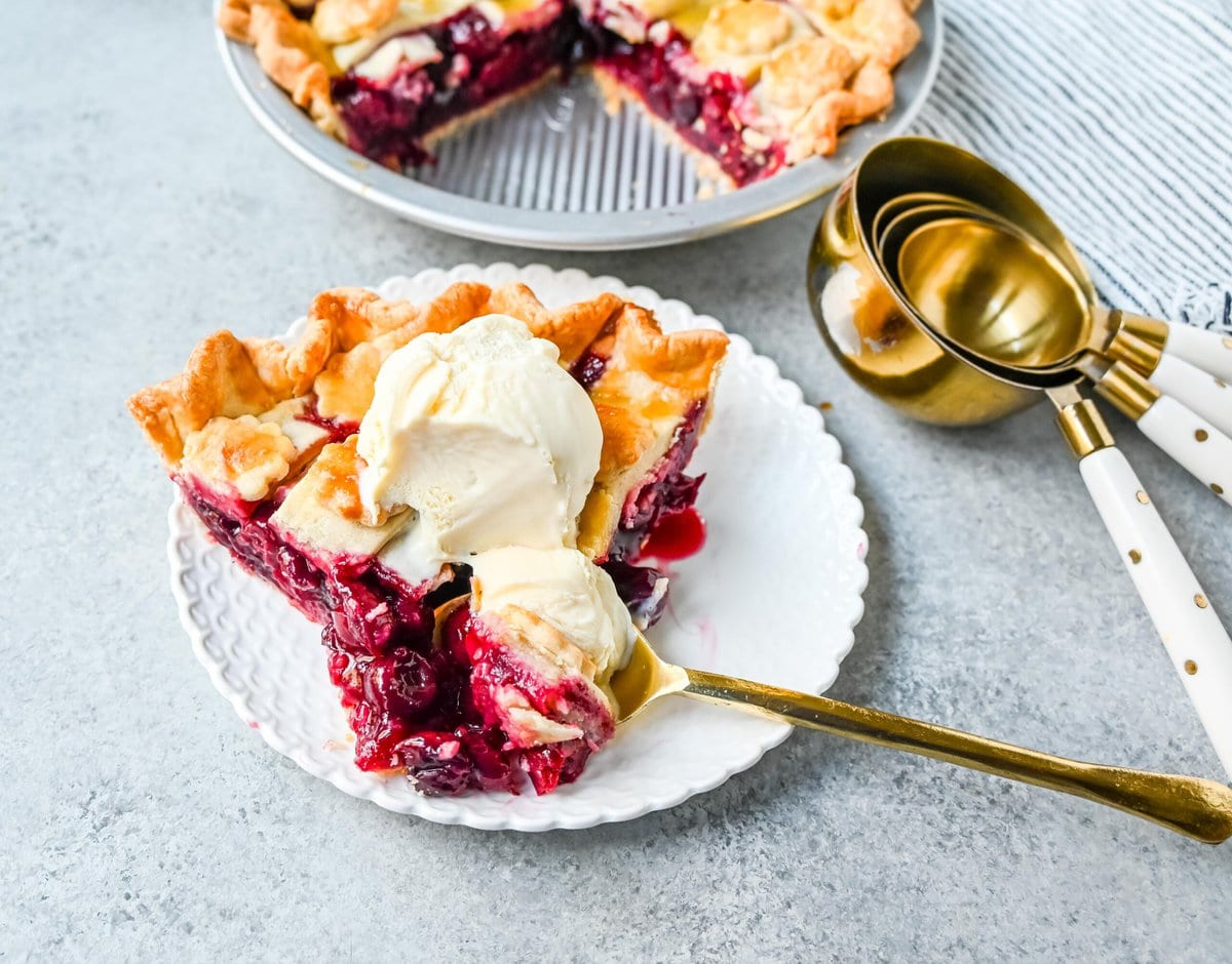 Homemade cherry pie is bursting with sweet-tart cherries nestled in a flaky, golden crust and topped with vanilla bean ice cream. I am sharing tips and tricks for making sweet cherry pie at home.