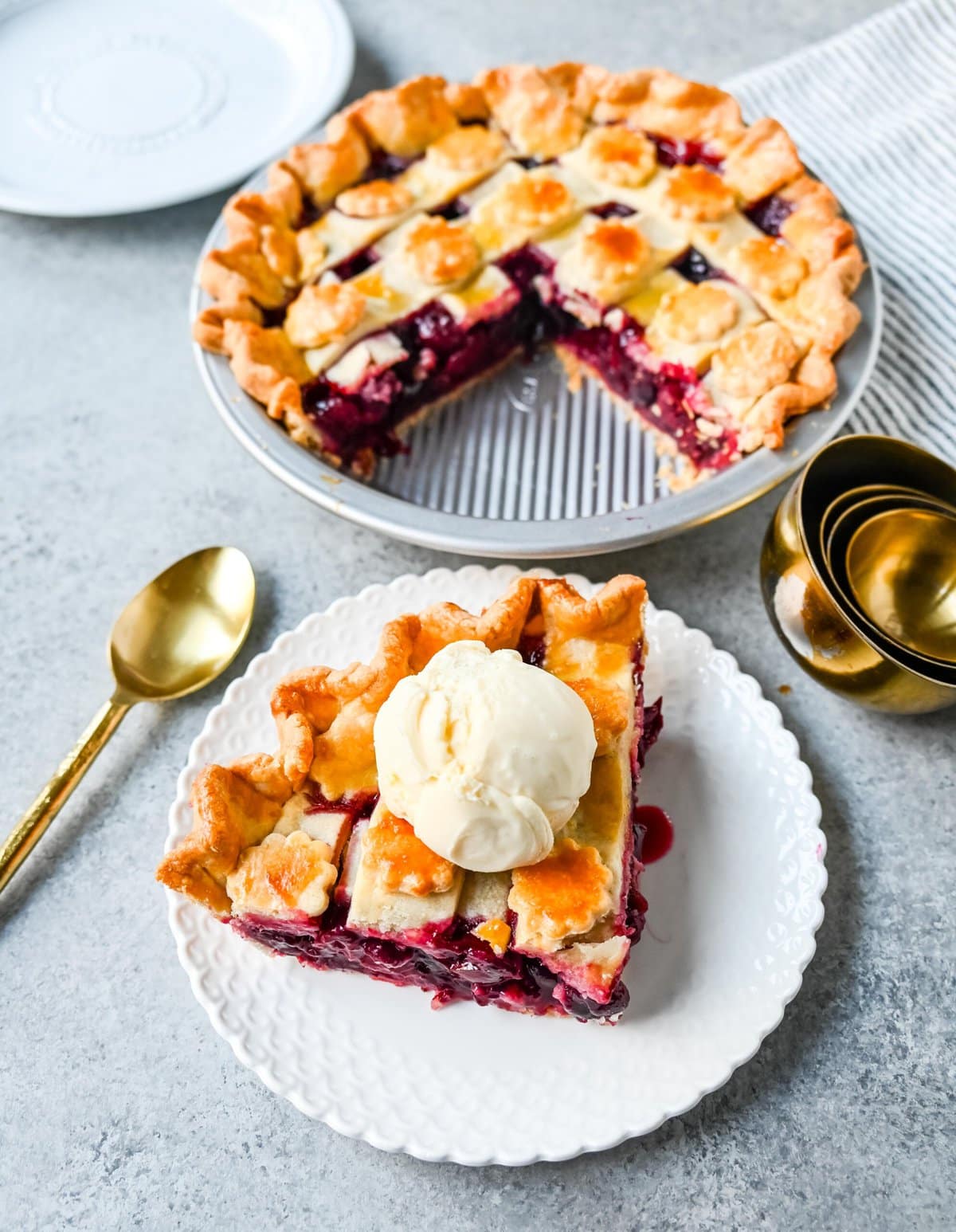 Homemade cherry pie is bursting with sweet-tart cherries nestled in a flaky, golden crust and topped with vanilla bean ice cream. I am sharing tips and tricks for making sweet cherry pie at home.