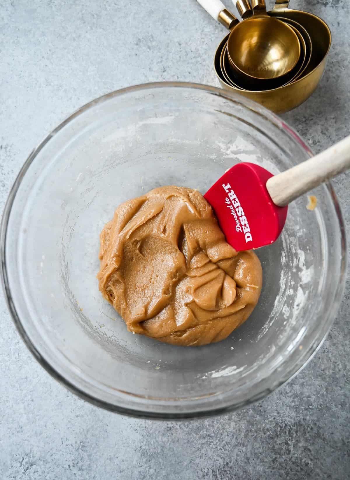 Mixing dry ingredients into the butter sugar mixture to make edible cookie dough