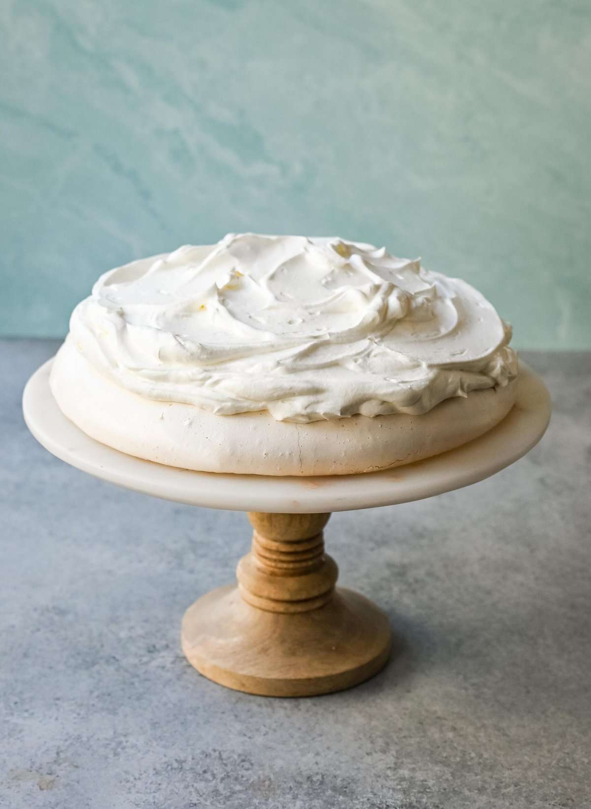 Pavlova is a stunning and elegant dessert with a crisp, crunchy outer shell with a soft, marshmallow-like center and topped with fresh whipped cream and fresh fruit. This homemade pavlova is a beautiful and delicious dessert.