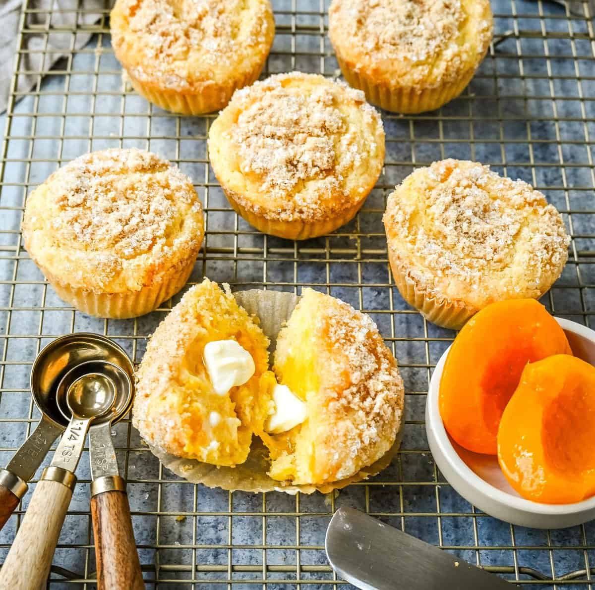 These Peach Cobbler Muffins are made with fresh, juicy peaches topped with a buttery streusel topping. These peach muffins are tender, moist, and bursting with fresh peach flavor and the sweetness of white chocolate chips.