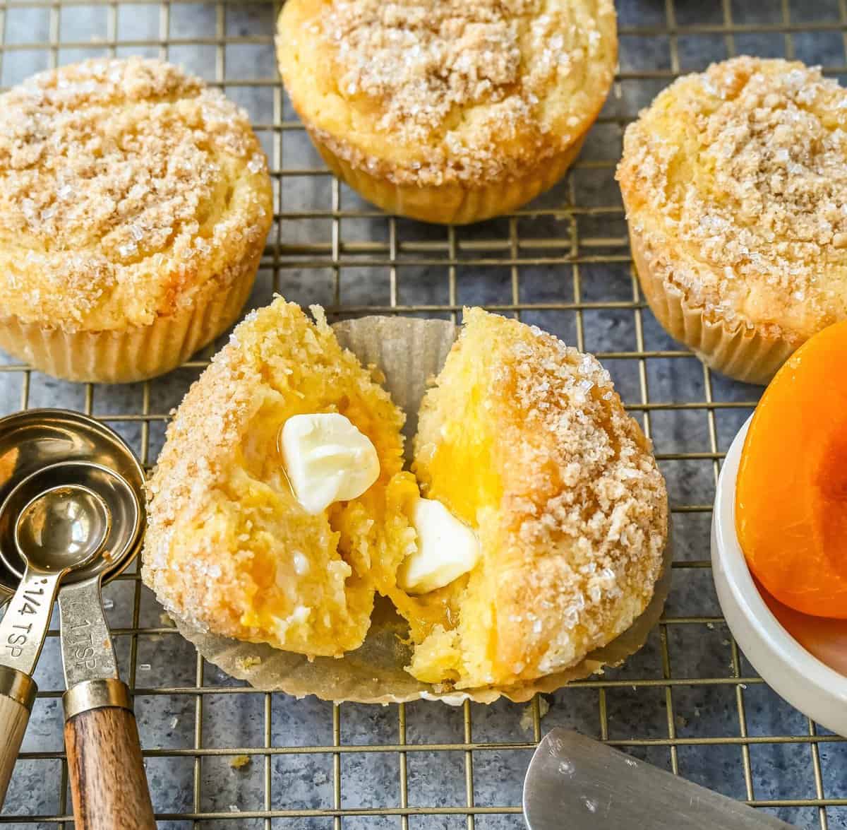 These Peach Cobbler Muffins are made with fresh, juicy peaches topped with a buttery streusel topping. These peach muffins are tender, moist, and bursting with fresh peach flavor and the sweetness of white chocolate chips.