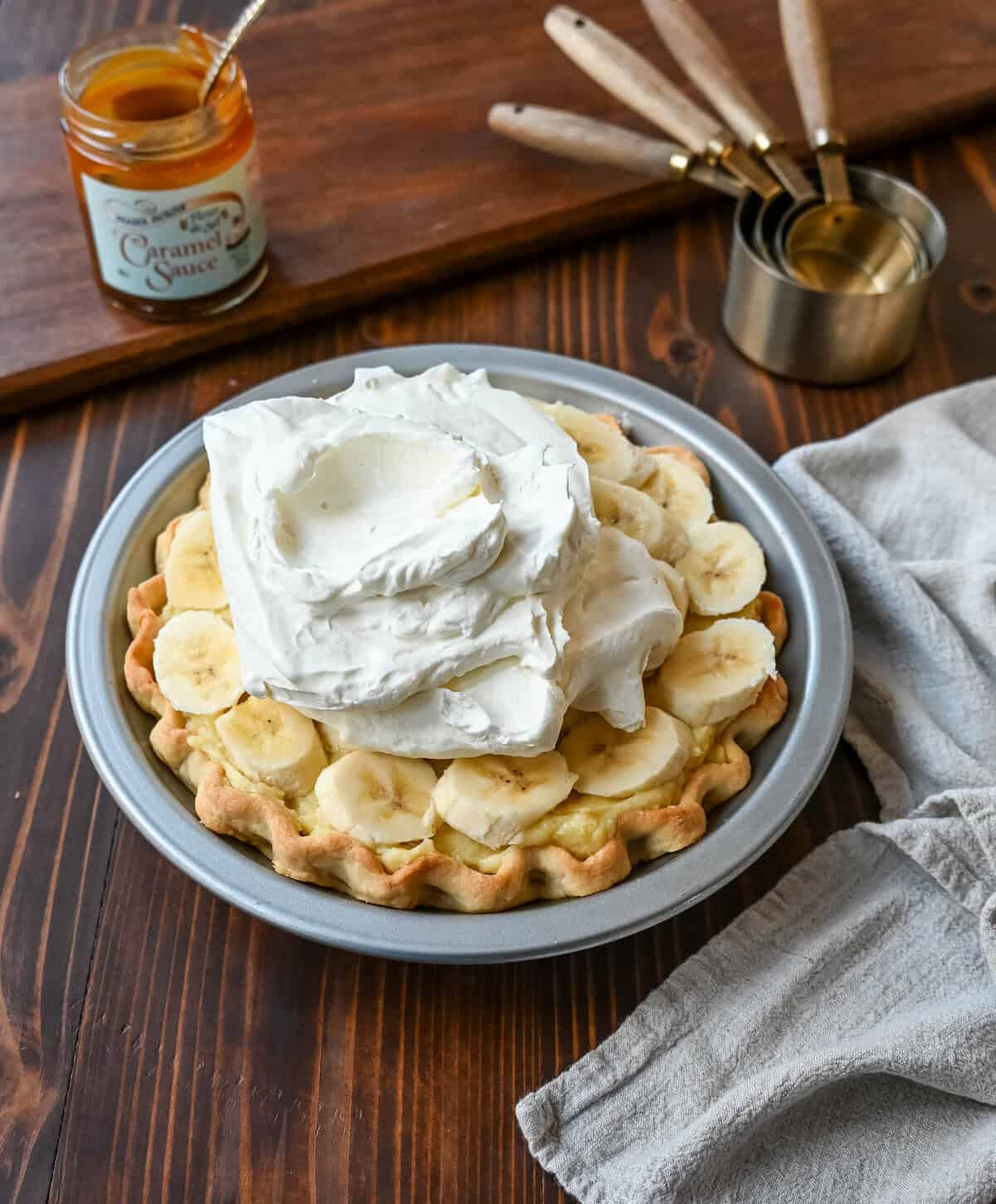 This Caramel Banana Cream Pie is made with a Homemade custard, fresh bananas, and rich salted caramel in a buttery pie crust. The ultimate caramel banana cream pie!