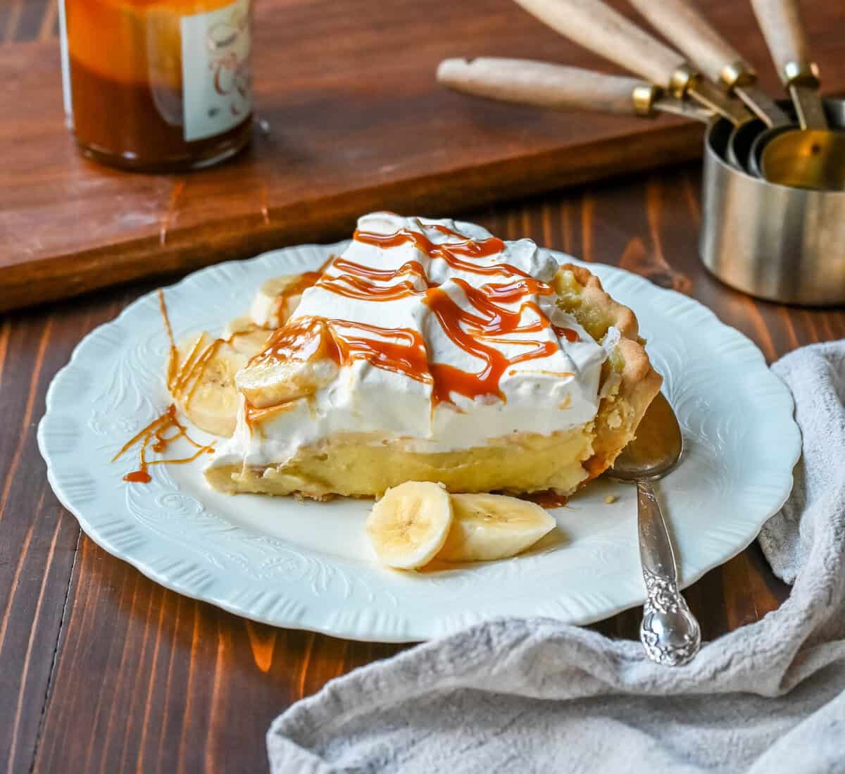 This Caramel Banana Cream Pie is made with a Homemade custard, fresh bananas, and rich salted caramel in a buttery pie crust. The ultimate caramel banana cream pie!