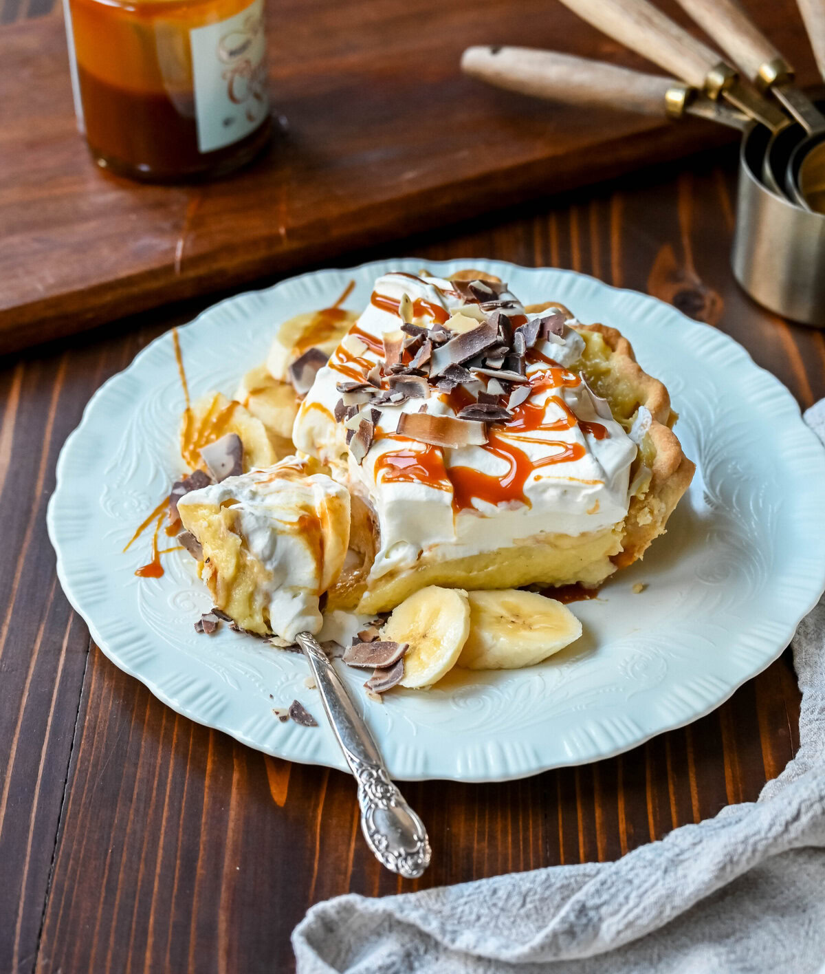 This Caramel Banana Cream Pie is made with a Homemade custard, fresh bananas, and rich salted caramel in a buttery pie crust. The ultimate caramel banana cream pie!