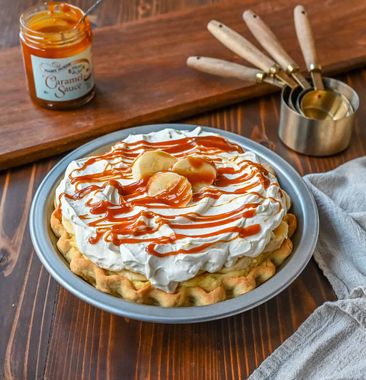 This Caramel Banana Cream Pie is made with a Homemade custard, fresh bananas, and rich salted caramel in a buttery pie crust. The ultimate caramel banana cream pie!