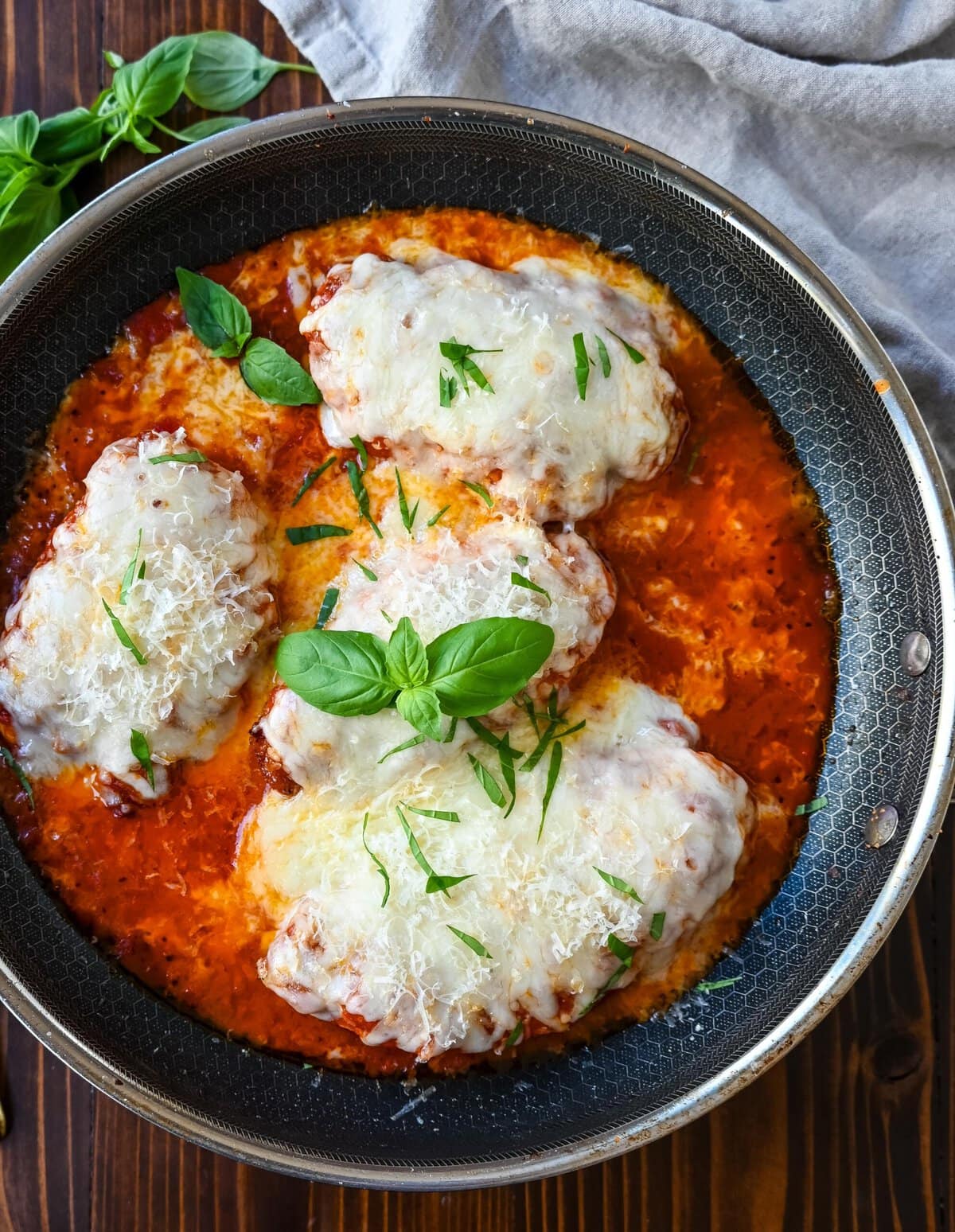 Skinny Chicken Parmesan is a healthier, lower fat version of chicken parmesan. Non-breaded chicken in a robust tomato sauce with creamy mozzarella cheese. A simple, easy, flavorful chicken dish!