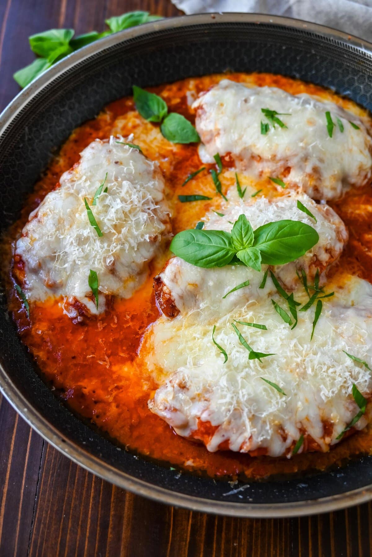 Skinny Chicken Parmesan is a healthier, lower fat version of chicken parmesan. Non-breaded chicken in a robust tomato sauce with creamy mozzarella cheese. A simple, easy, flavorful chicken dish!