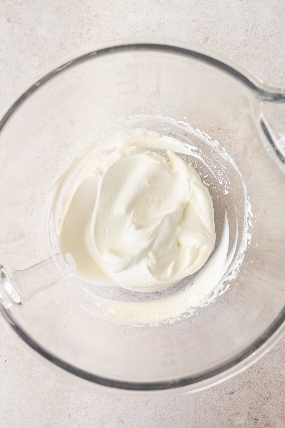 Whipped cream in a bowl to fold into pudding mixture to make easy banana cream pie