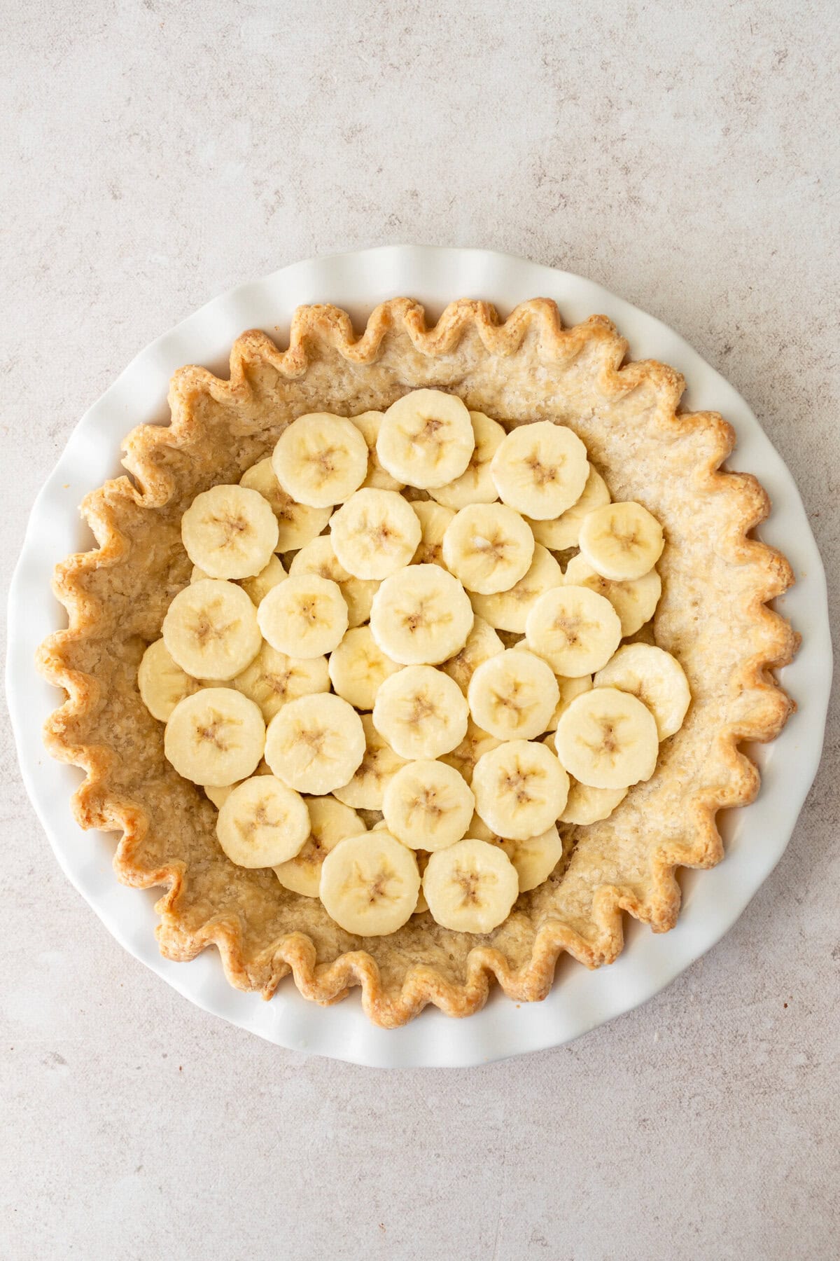 Layer bananas in the pre-baked pie crust to make easy banana cream pie.