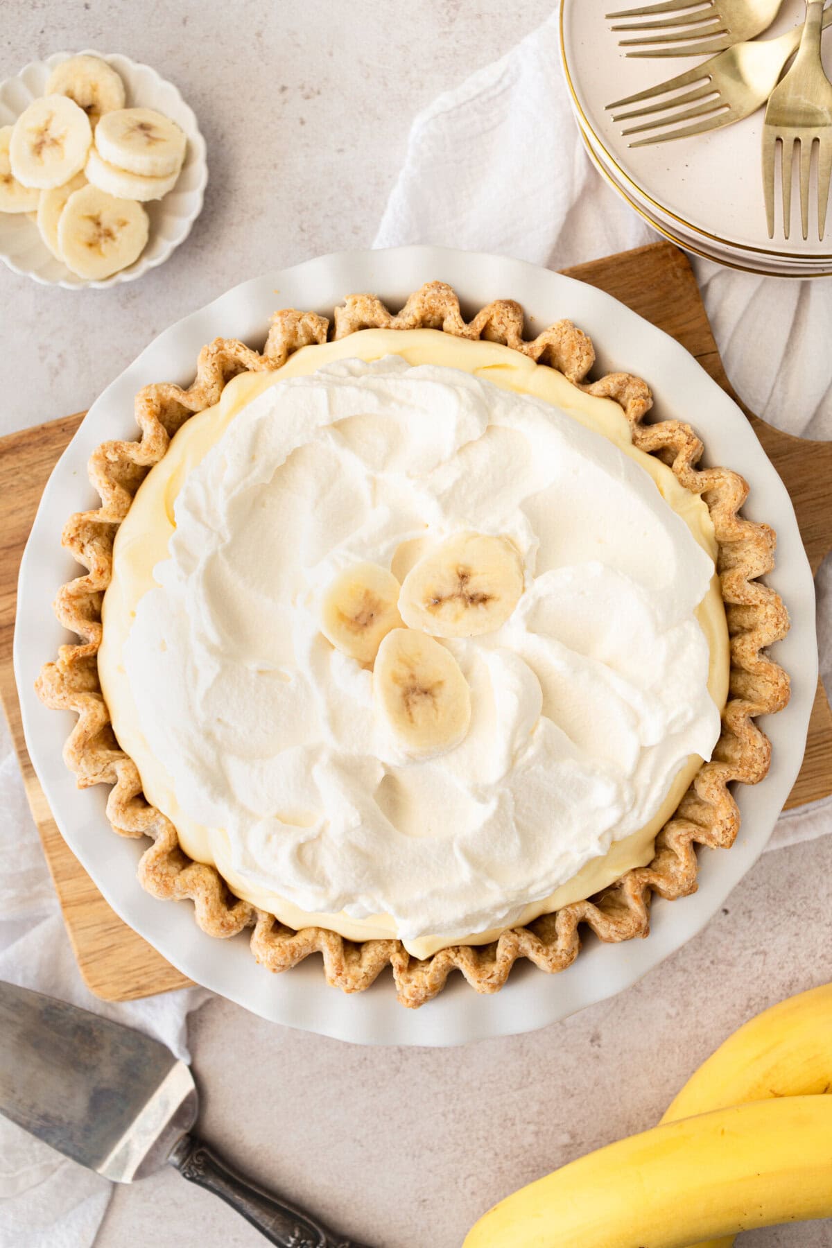 Indulge in the sweet and creamy goodness of this classic dessert. This Banana Cream Pie Recipe is made with a buttery crust, smooth vanilla custard, fresh bananas, and topped with fluffy whipped cream. This easy banana cream pie is sure to satisfy any sweet tooth.