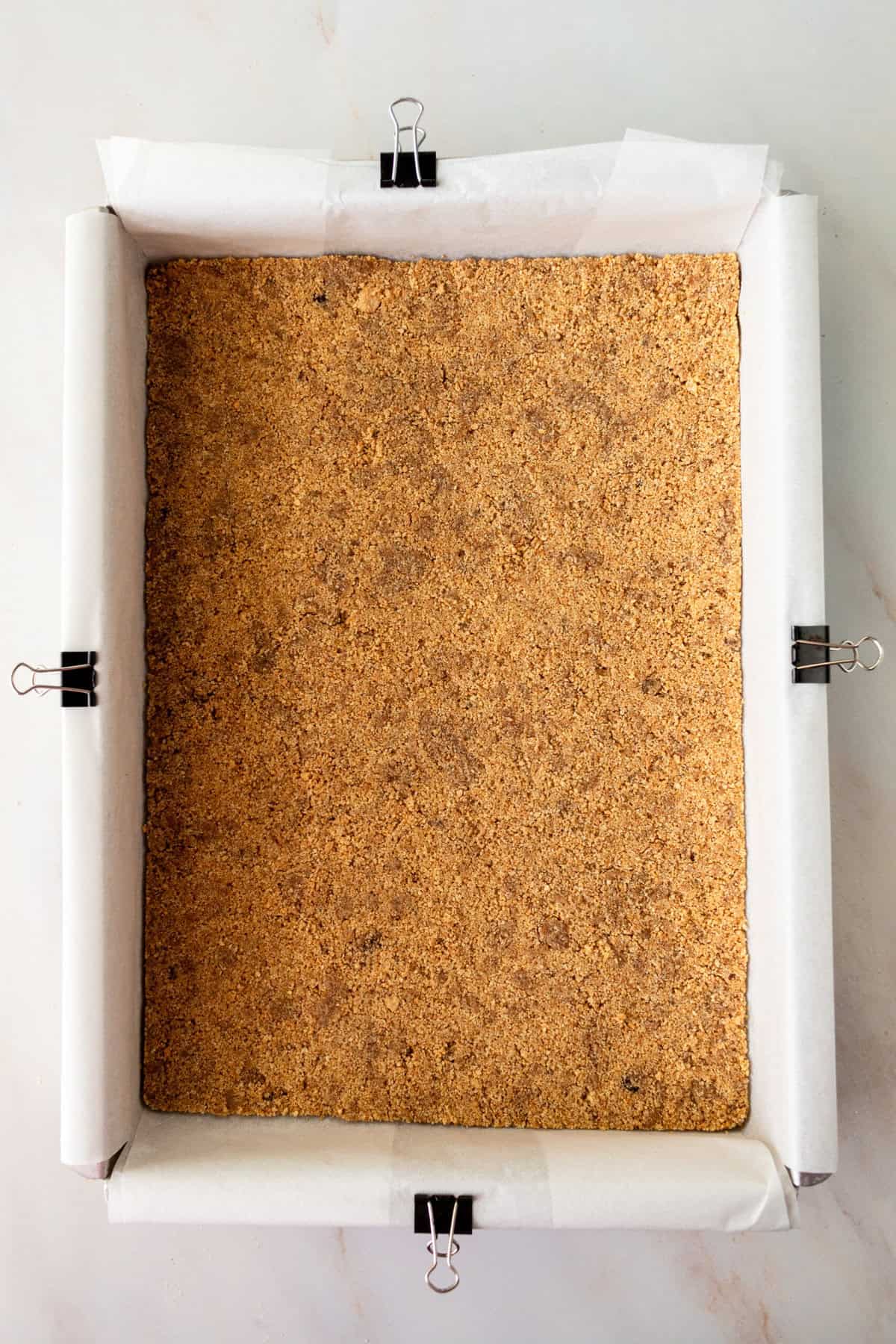 Making cheesecake bars with a graham cracker crust in a 9 x 13 pan