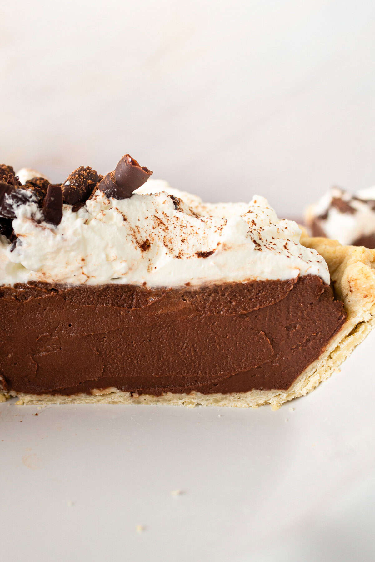 This is the best Chocolate Cream Pie recipe made with decadent chocolate custard in a flaky, buttery crust and topped with homemade whipped cream and chocolate shavings. You will love this chocolate pie recipe! 