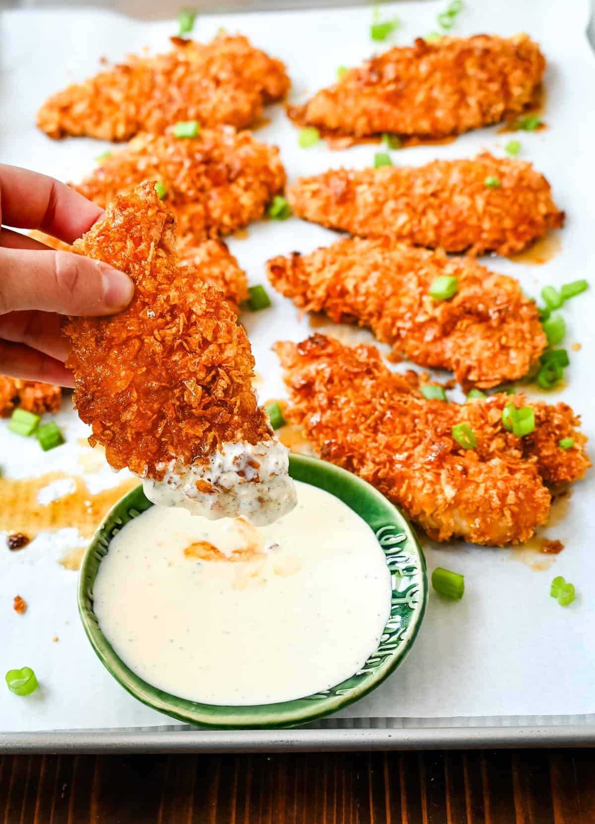 Tender, juicy chicken coated in a crispy cornflake crust that is baked to golden perfection, and then drizzled with sweet and spicy hot honey. These Crispy Crunchy Hot Honey Chicken Tenders deliver the perfect balance of crunch and heat, with a mouthwatering sticky glaze that keeps you coming back for more. 