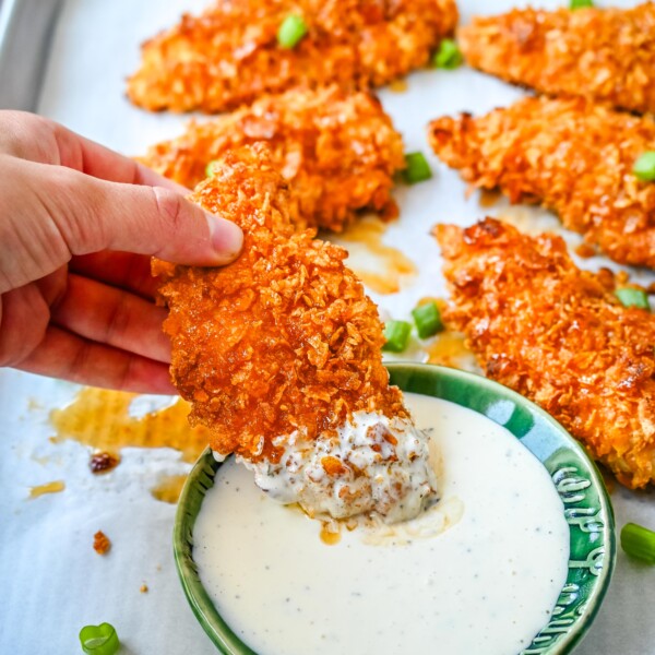 Tender, juicy chicken coated in a crispy cornflake crust that is baked to golden perfection, and then drizzled with sweet and spicy hot honey. These Crispy Crunchy Hot Honey Chicken Tenders deliver the perfect balance of crunch and heat, with a mouthwatering sticky glaze that keeps you coming back for more.