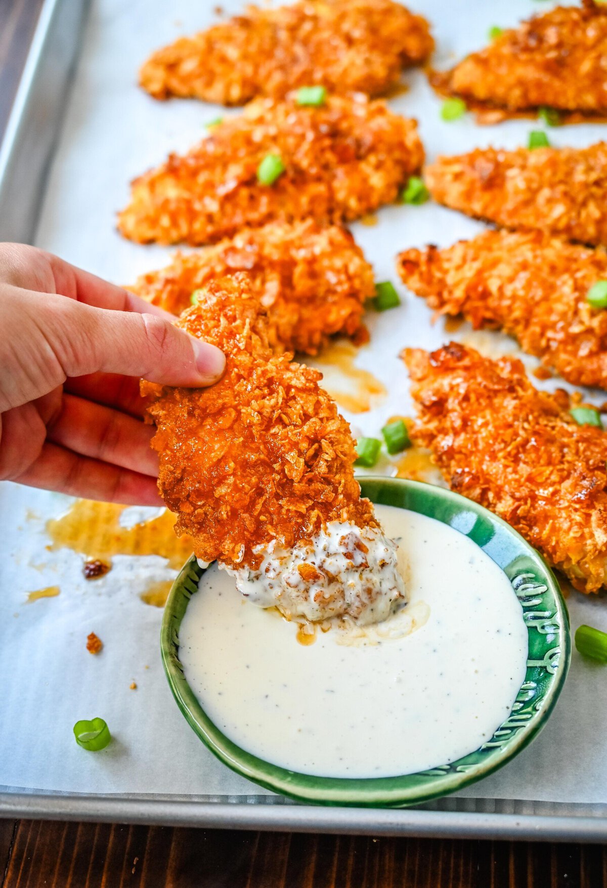 Tender, juicy chicken coated in a crispy cornflake crust that is baked to golden perfection, and then drizzled with sweet and spicy hot honey. These Crispy Crunchy Hot Honey Chicken Tenders deliver the perfect balance of crunch and heat, with a mouthwatering sticky glaze that keeps you coming back for more. 