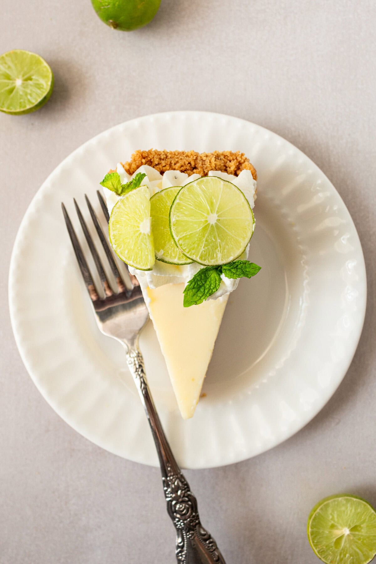 Learn how to make the best key lime pie with a perfectly sweet and buttery graham cracker crust. This easy key lime pie recipe features fresh key lime juice for a tangy, refreshing filling, balanced with the sweetness of condensed milk. Ideal for summer gatherings or as a classic dessert, follow our step-by-step guide to create this homemade key lime pie that everyone will love! A slice of key lime pie