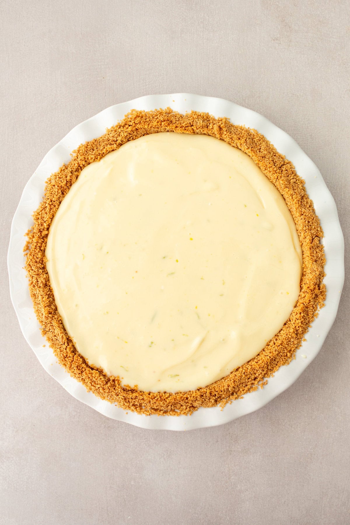 Key Lime Filling in graham cracker crust ready to be baked