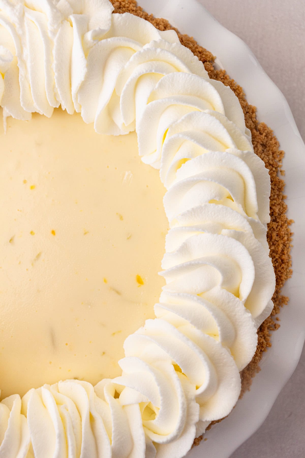 Fresh whipped cream  piped on key lime pie