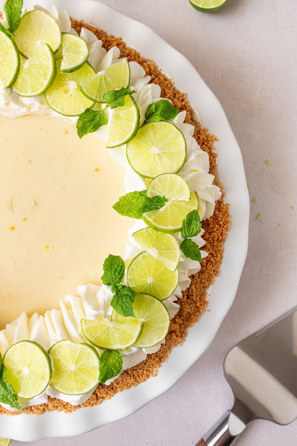 Learn how to make the best key lime pie with a perfectly sweet and buttery graham cracker crust. This easy key lime pie recipe features fresh key lime juice for a tangy, refreshing filling, balanced with the sweetness of condensed milk. Ideal for summer gatherings or as a classic dessert, follow our step-by-step guide to create this homemade key lime pie that everyone will love! Key Lime Pie with graham cracker crust and whipped cream.